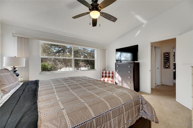 bedroom featuring light carpet, lofted ceiling, and ceiling fan