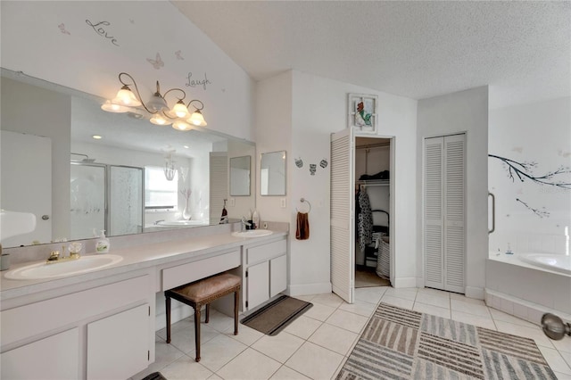 bathroom featuring vanity, a textured ceiling, tile patterned flooring, and plus walk in shower