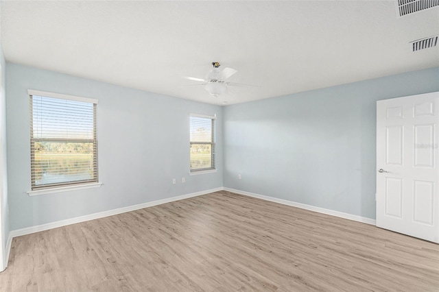 empty room featuring light wood-type flooring and ceiling fan