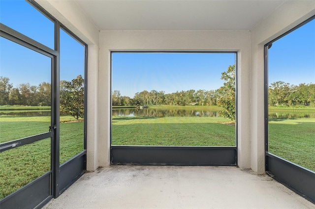 unfurnished sunroom featuring a water view and plenty of natural light