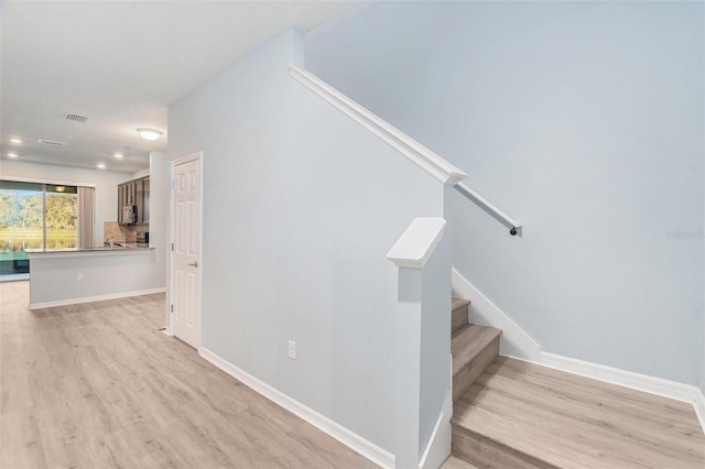 stairs with hardwood / wood-style flooring