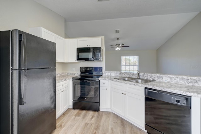 kitchen featuring ceiling fan, sink, black appliances, light hardwood / wood-style flooring, and white cabinetry