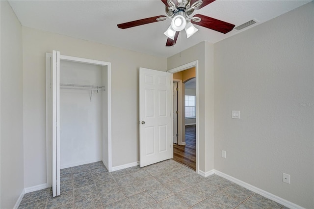 3776 Junction St, North Port, FL 34288 - unfurnished bedroom with a closet, a ceiling fan, baseboards, and arched walkways