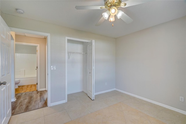 unfurnished bedroom with a closet, light hardwood / wood-style flooring, and ceiling fan