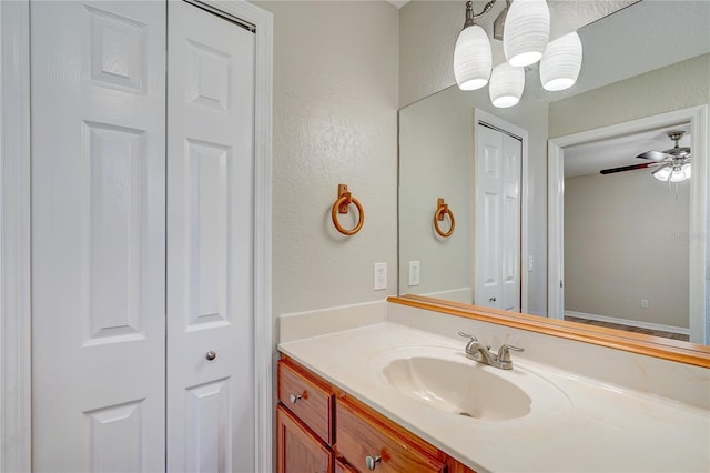 bathroom with ceiling fan and vanity