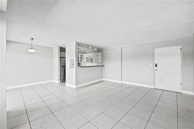 unfurnished living room with electric panel, a textured ceiling, baseboards, and light tile patterned floors