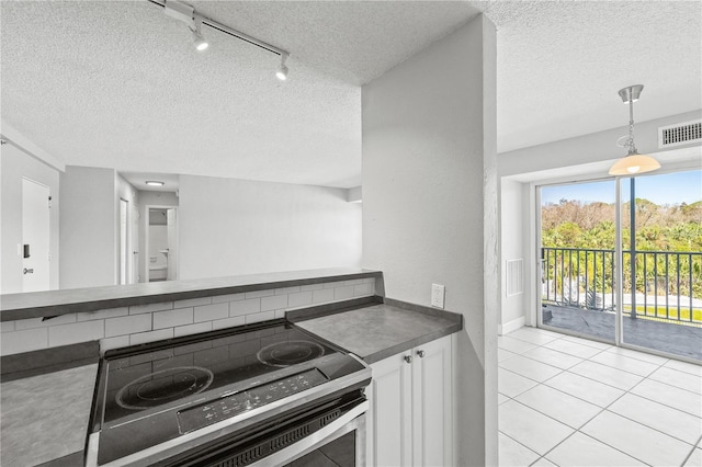 kitchen with stainless steel range with electric stovetop, a textured ceiling, track lighting, and white cabinets