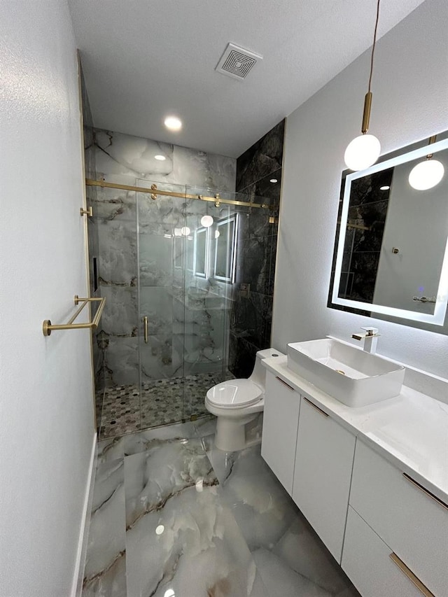 bathroom with toilet, vanity, a textured ceiling, and a shower with door