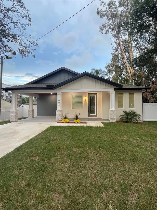 view of front of property with a front lawn and a carport