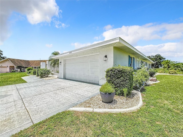 view of property exterior featuring a garage and a lawn