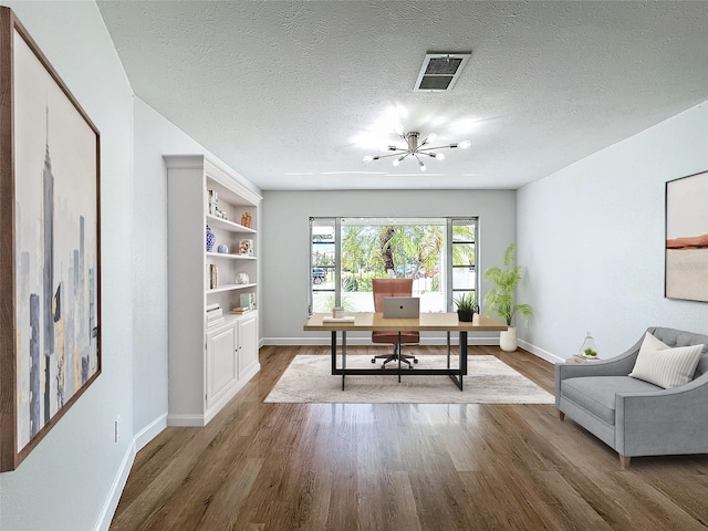 office space with a textured ceiling, a chandelier, and dark hardwood / wood-style flooring