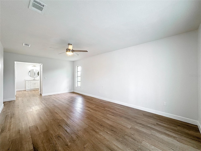 spare room with ceiling fan and hardwood / wood-style flooring