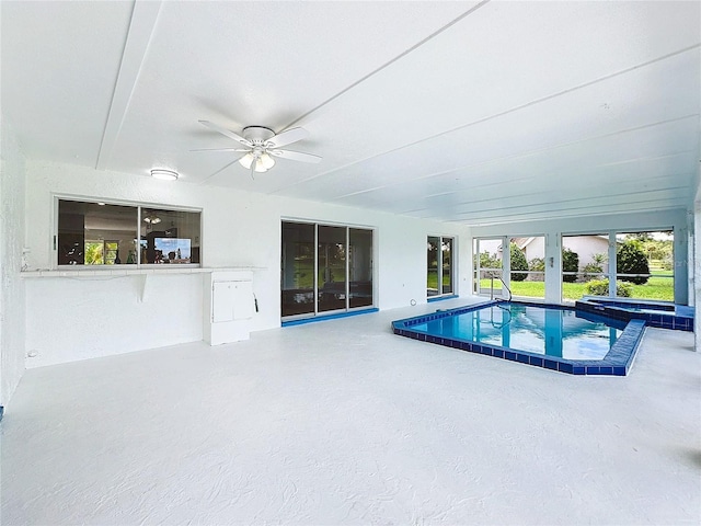 view of swimming pool with an in ground hot tub, a patio area, and ceiling fan