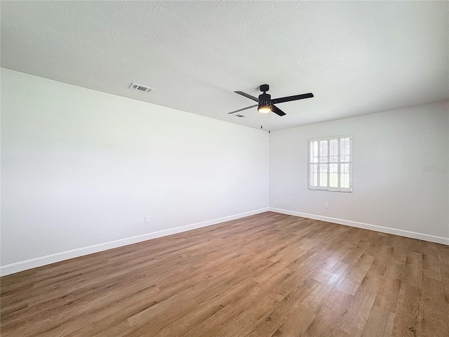 unfurnished room featuring a textured ceiling, light hardwood / wood-style floors, and ceiling fan