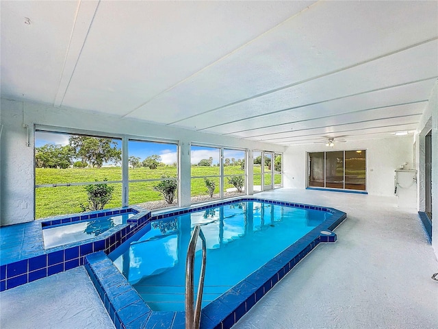 view of pool featuring a patio area and an in ground hot tub