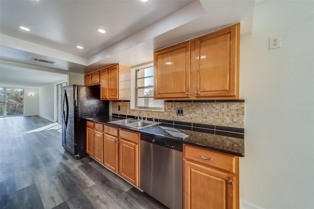 kitchen featuring stainless steel dishwasher, decorative backsplash, a healthy amount of sunlight, and dark hardwood / wood-style flooring