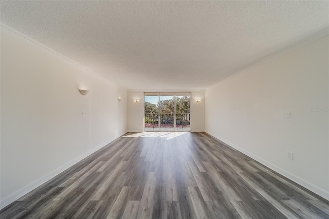 empty room with ornamental molding, a textured ceiling, and dark hardwood / wood-style floors