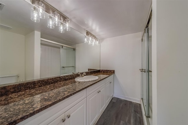 bathroom with vanity, walk in shower, hardwood / wood-style flooring, and toilet