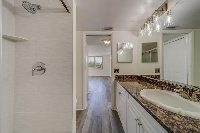 bathroom with vanity, a shower, and hardwood / wood-style floors