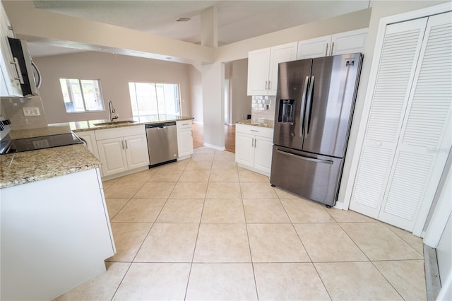 kitchen with decorative backsplash, sink, white cabinetry, and stainless steel appliances