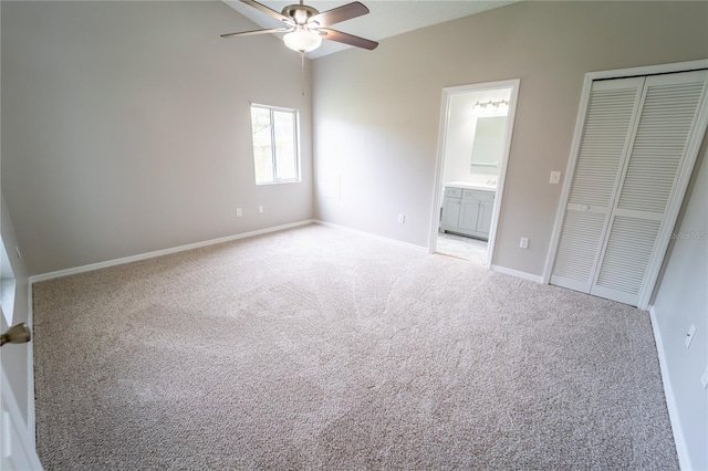 unfurnished bedroom with light carpet, connected bathroom, a closet, and ceiling fan