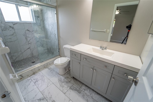 bathroom with walk in shower, ceiling fan, vanity, and toilet