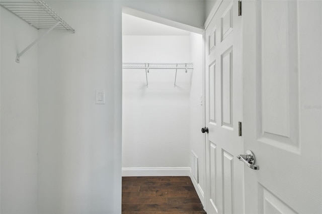 spacious closet featuring dark hardwood / wood-style flooring