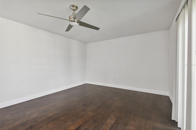 empty room with ceiling fan and dark hardwood / wood-style flooring