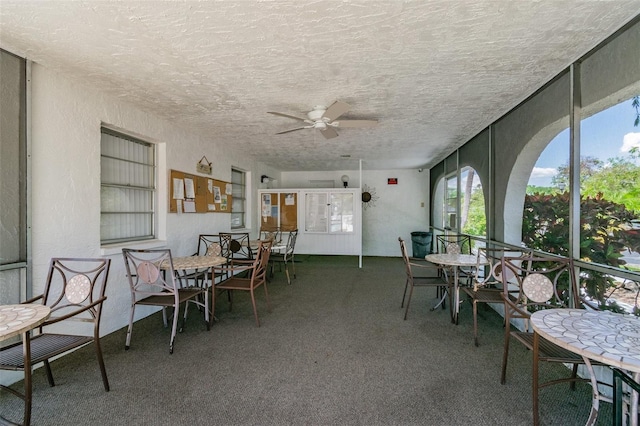 sunroom / solarium featuring ceiling fan