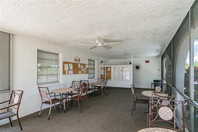 dining room featuring carpet, a textured ceiling, and ceiling fan