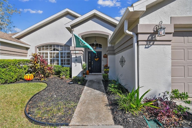 doorway to property with a yard and a garage