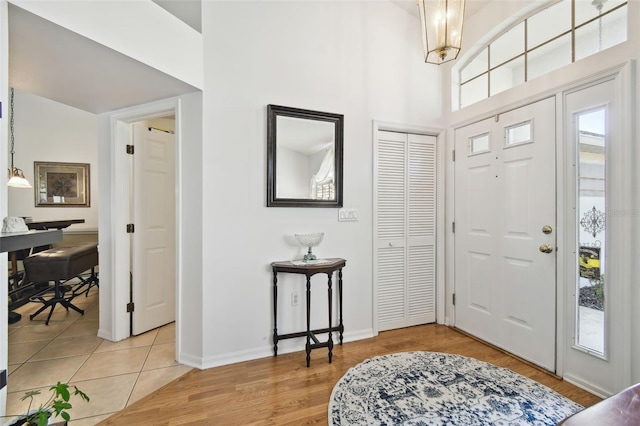 entrance foyer with hardwood / wood-style floors and a high ceiling