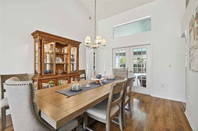 dining space featuring french doors, high vaulted ceiling, dark hardwood / wood-style flooring, and a chandelier