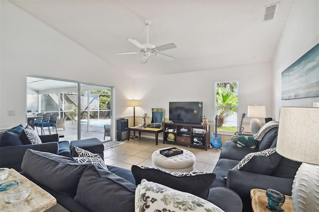 tiled living room featuring high vaulted ceiling and ceiling fan