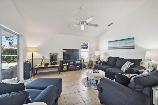 living room with ceiling fan, high vaulted ceiling, and light tile patterned flooring