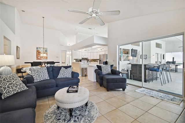 living room with light tile patterned flooring, high vaulted ceiling, and ceiling fan