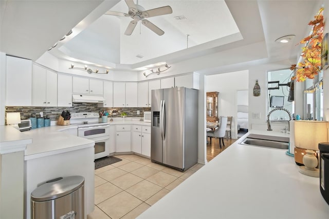 kitchen with sink, white electric stove, stainless steel fridge with ice dispenser, white cabinets, and light tile patterned floors