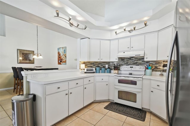 kitchen with white cabinets, hanging light fixtures, electric range, and stainless steel fridge