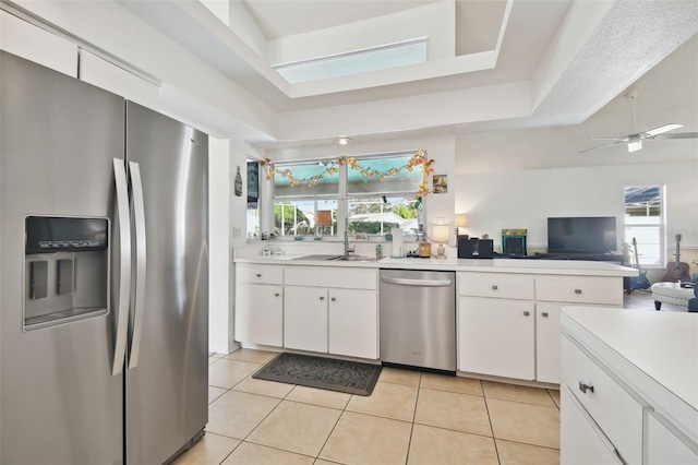 kitchen featuring white cabinetry, appliances with stainless steel finishes, and plenty of natural light