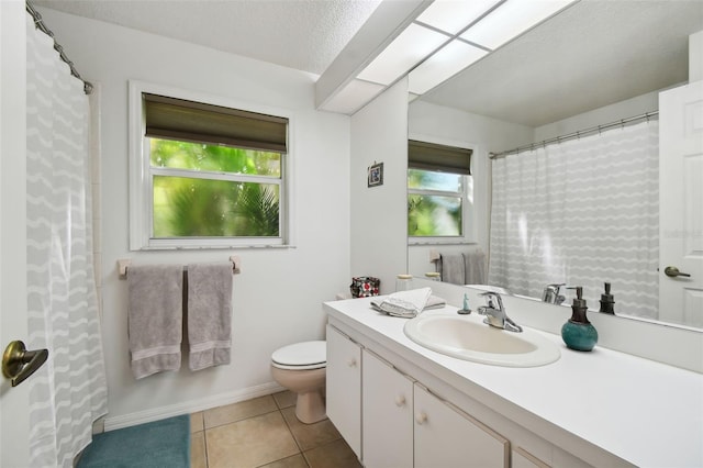 bathroom with vanity, a textured ceiling, toilet, and tile patterned flooring