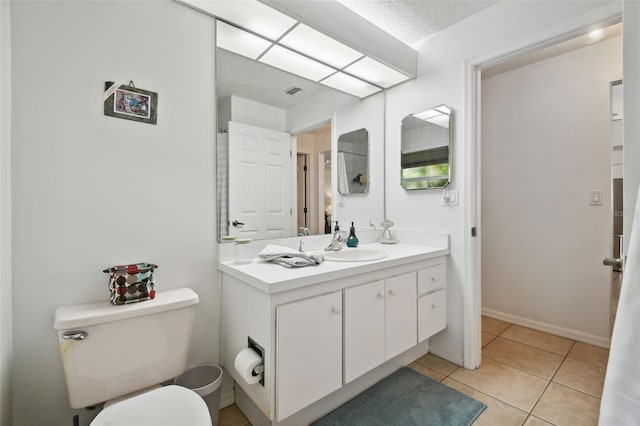 bathroom featuring vanity, toilet, and tile patterned flooring