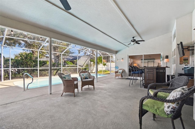 view of patio featuring a lanai and ceiling fan