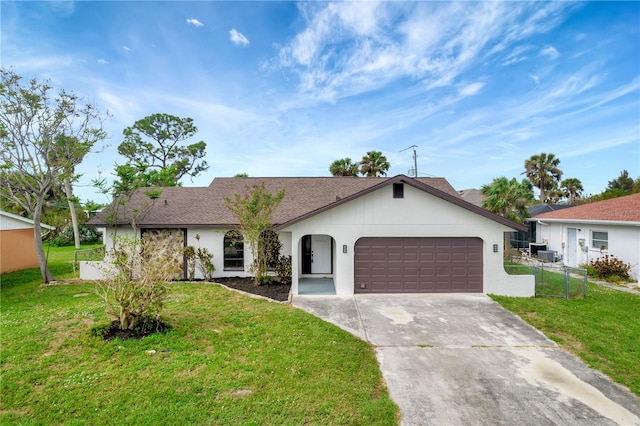 single story home featuring central air condition unit, a garage, and a front yard