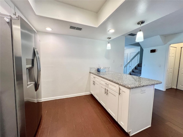 kitchen featuring kitchen peninsula, light stone countertops, stainless steel fridge with ice dispenser, pendant lighting, and white cabinetry