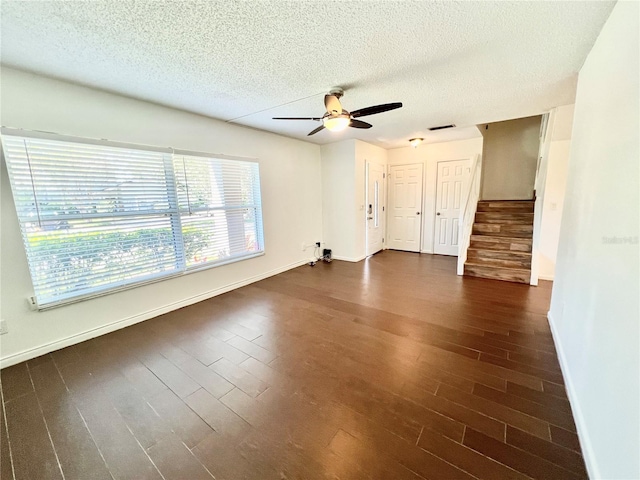 spare room featuring a textured ceiling, dark hardwood / wood-style floors, and ceiling fan