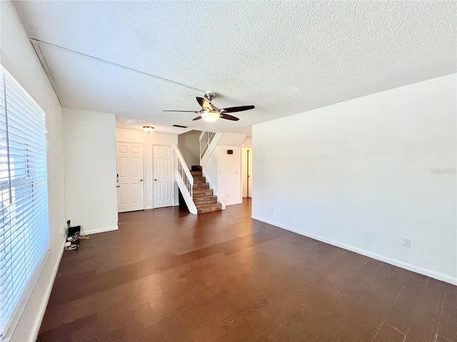 unfurnished living room with a textured ceiling and ceiling fan