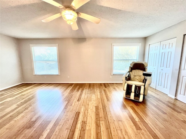 unfurnished room featuring hardwood / wood-style floors, a textured ceiling, and ceiling fan