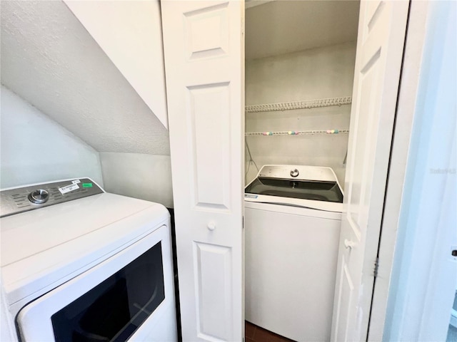 laundry room featuring washing machine and dryer