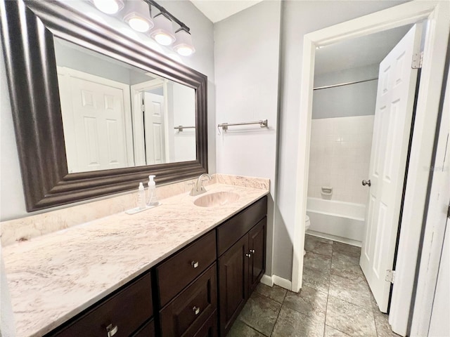 full bathroom with vanity, toilet, and  shower combination