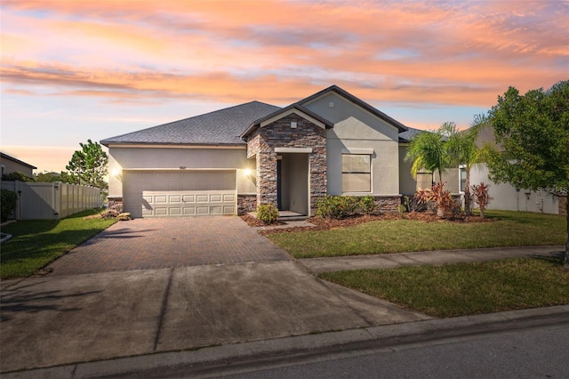 view of front of home featuring a garage and a lawn